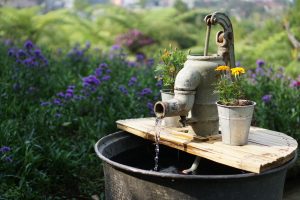 old water pump in a flower garden